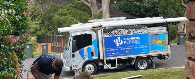 A Plumber Working Next To A Truck
