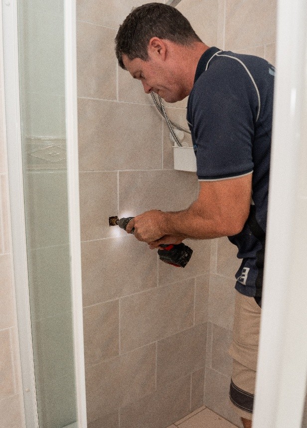 Top 5 Signs You’ve Got A Hidden Leak (And Why You Shouldn’t Ignore It) A Man Using A Drill To Drill A Hole In A Wall